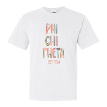 Load image into Gallery viewer, Phi Chi Theta Pastel Stencil Comfort Colors T-Shirt - Kite and Crest

