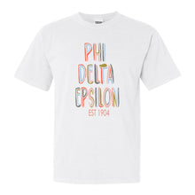 Load image into Gallery viewer, Phi Delta Epsilon Pastel Stencil Comfort Colors T-Shirt - Kite and Crest
